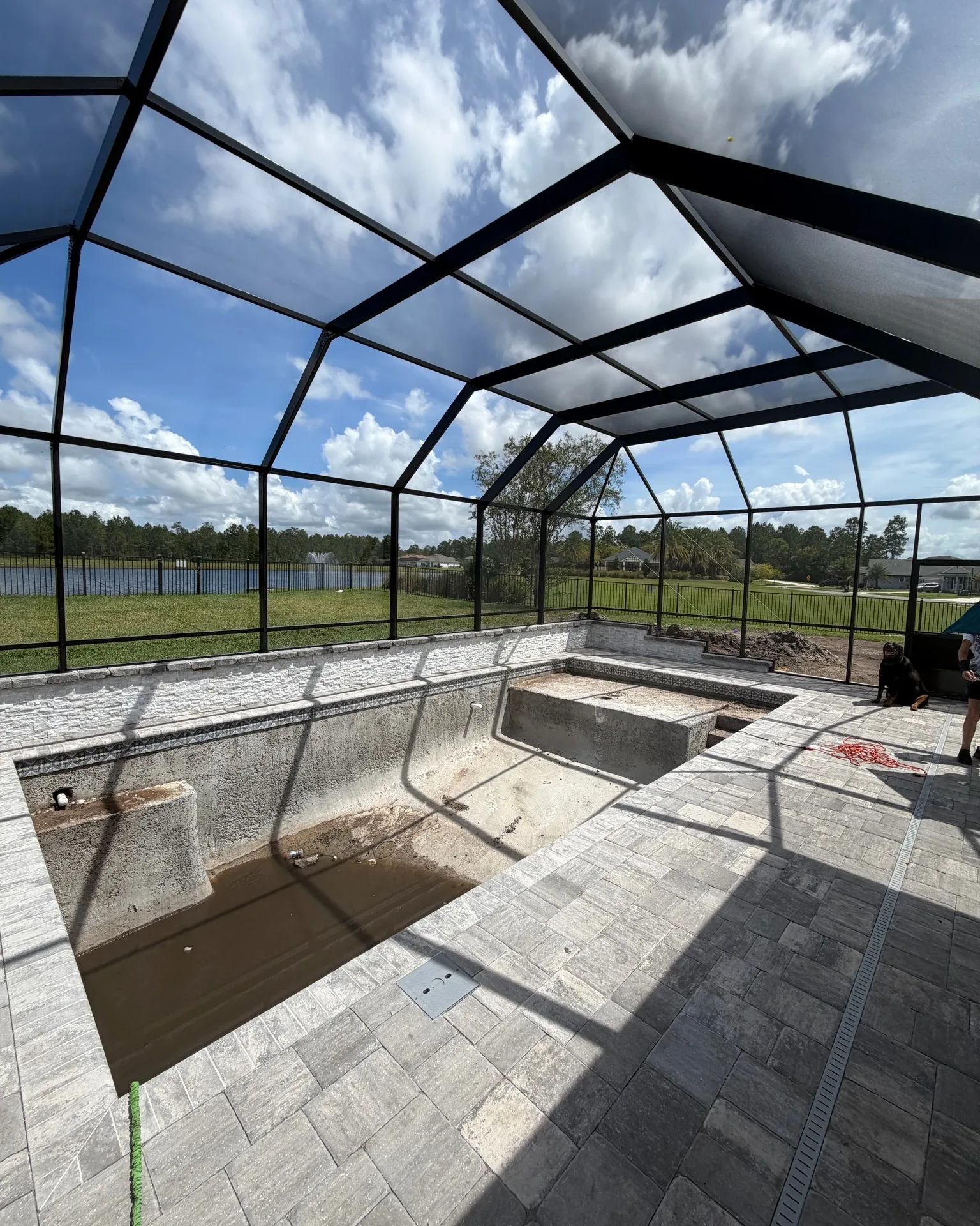 Screened pool under construction with pavers down built by Scott's Pools & Spas in Jacksonville