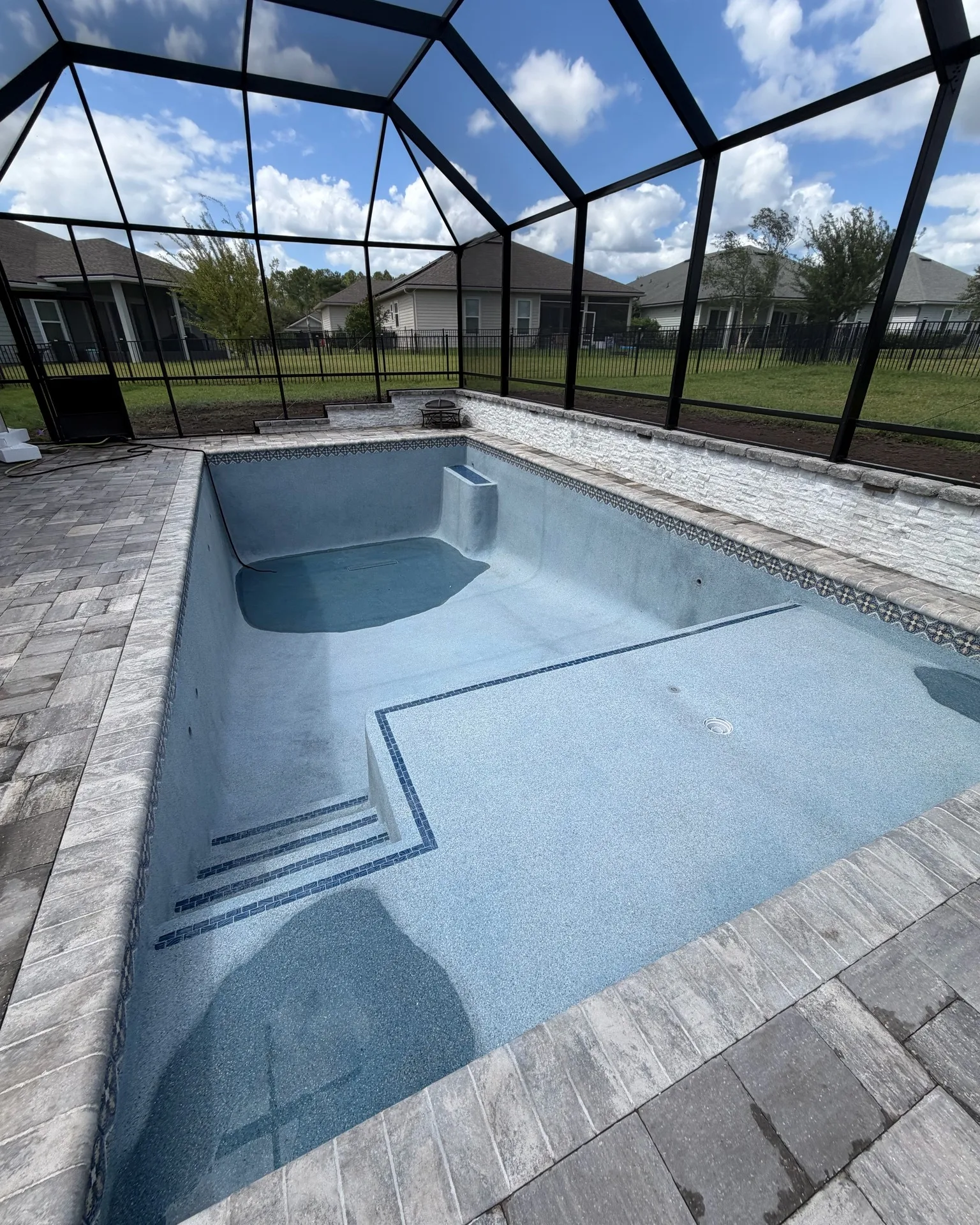 Custom pool with fresh finish and waterline tile built by Scott's Pools & Spas in Jacksonville