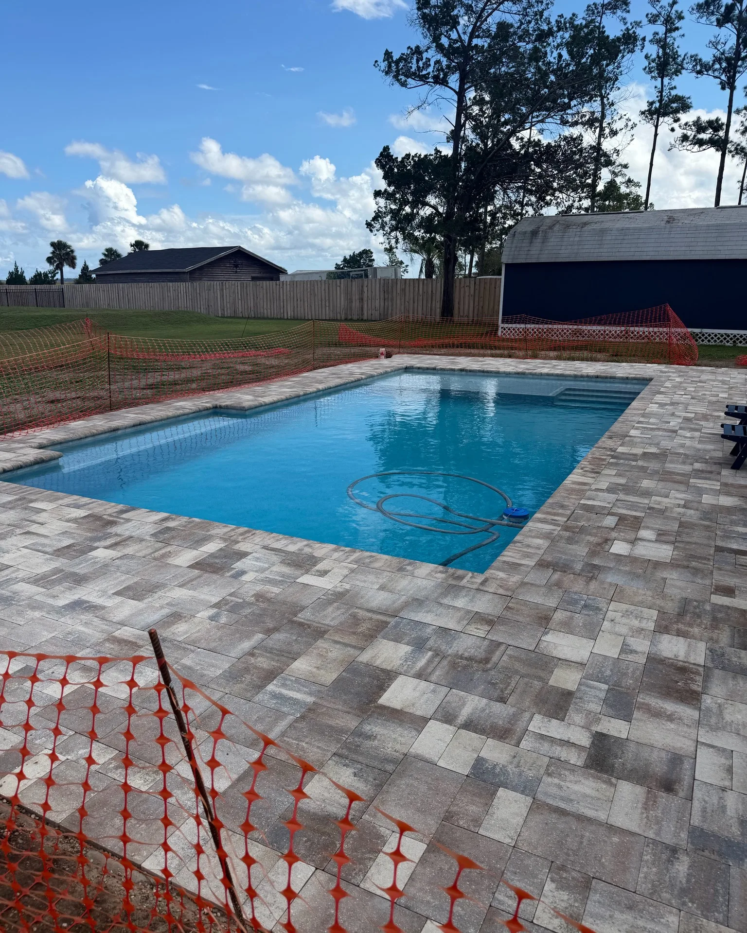 Finished custom pool with new paver deck built by Scott's Pools & Spas in Jacksonville