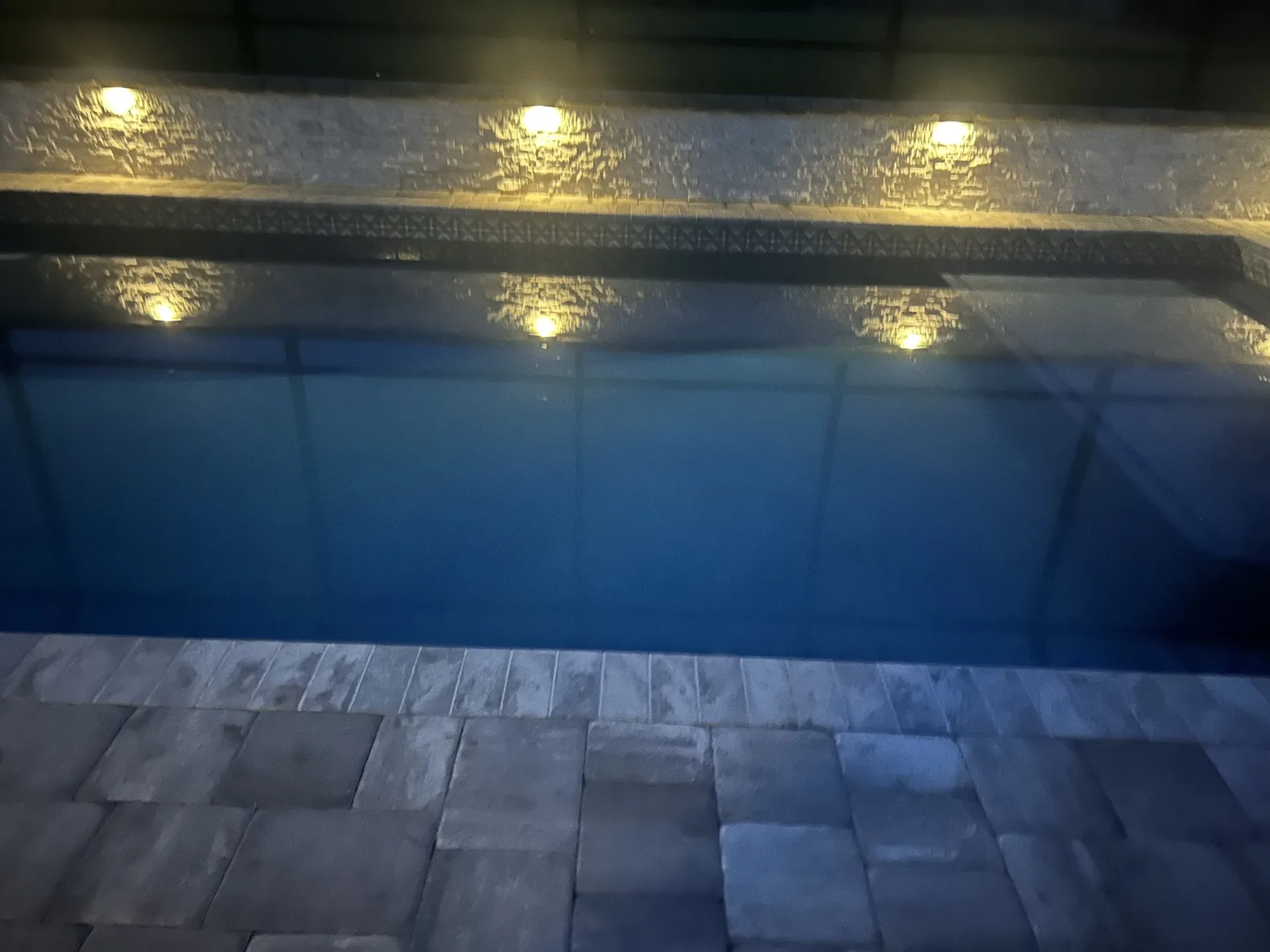Custom pool with lighting at night built by Scott's Pools & Spas in Jacksonville
