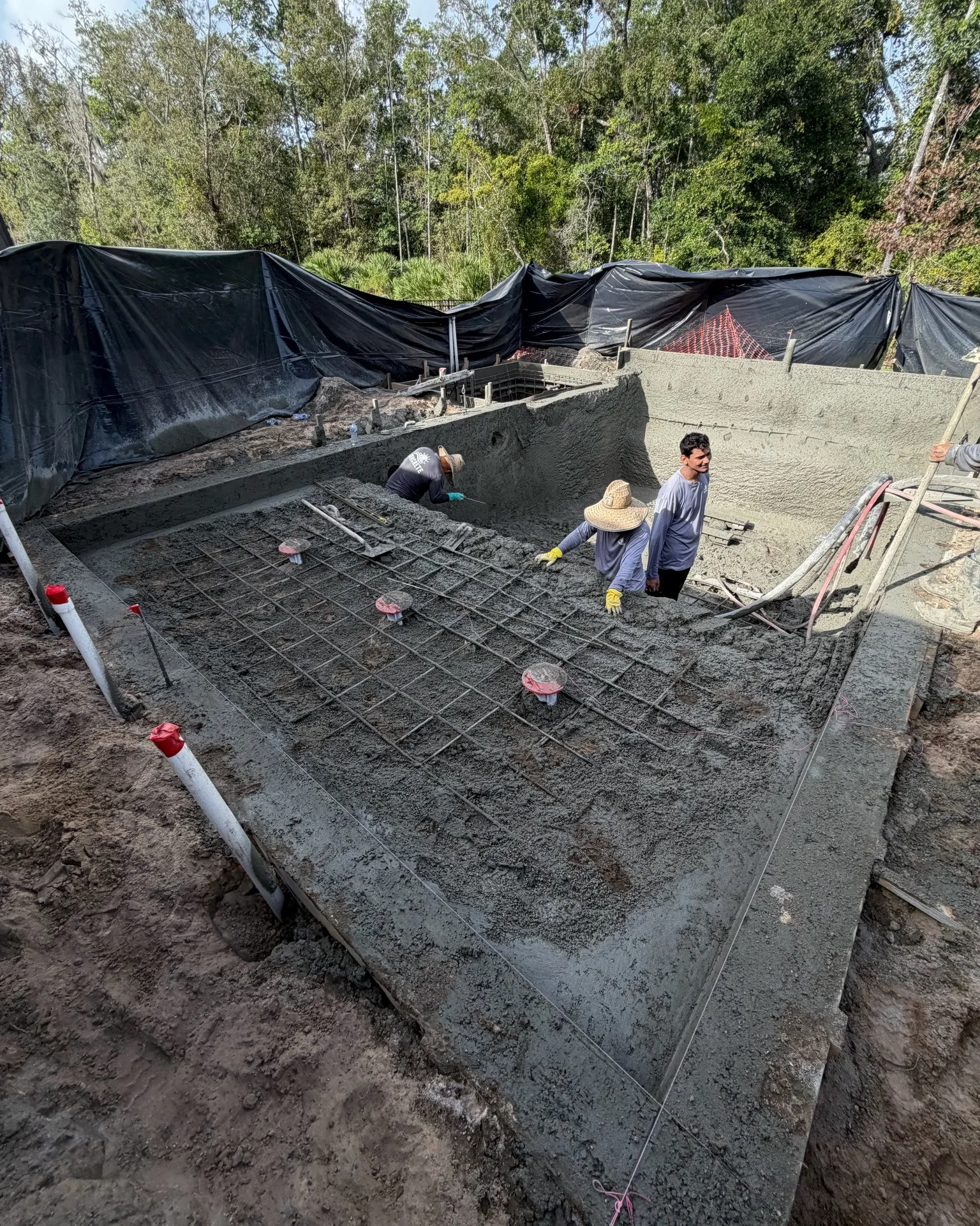 Crew shooting shotcrete on a new pool shell by Scott's Pools & Spas in Jacksonville
