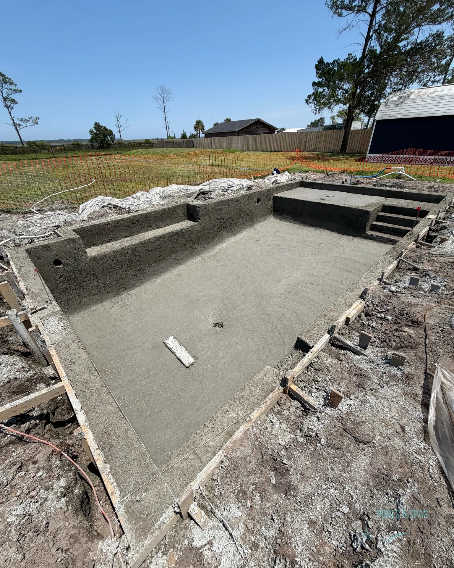 Shotcrete pool shell with sun shelf and steps built by Scott's Pools & Spas in Jacksonville
